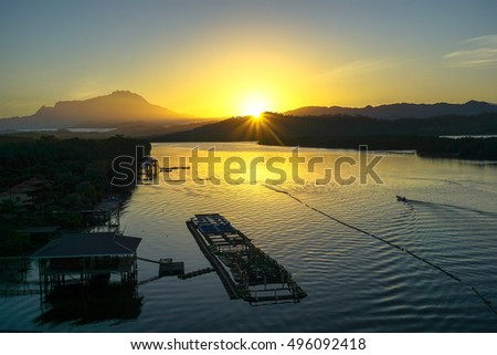 The landscape picture of Mengkabong river,mangrove forest & Mountain Kinabalu from the view point of Mengkabong bridge during sunrise at Tuaran,Sabah,Borneo.
