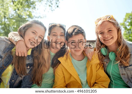 friendship and people concept - group of happy teenage students or friends outdoors