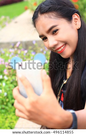 woman taking picture of herself in park