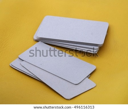 Template of business kraft-paper cards isolated on yellow background  to demonstrate the design of the customer