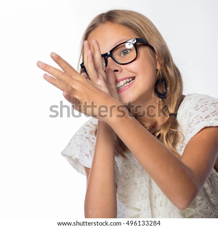 Emotional blonde girl in a white dress with glasses on a white background