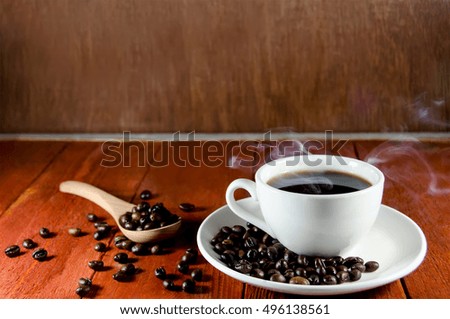 Coffee cup and saucer on a wooden table - vintage style effect picture