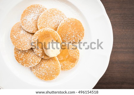 Pancake with butter on top in white plate