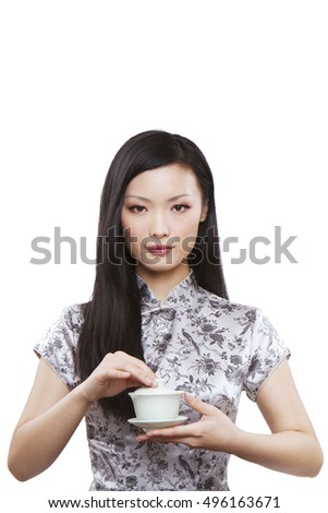 Wear cheongsam Oriental young female holding a cup of tea
