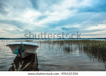 Evening landscape at the lake with the boat