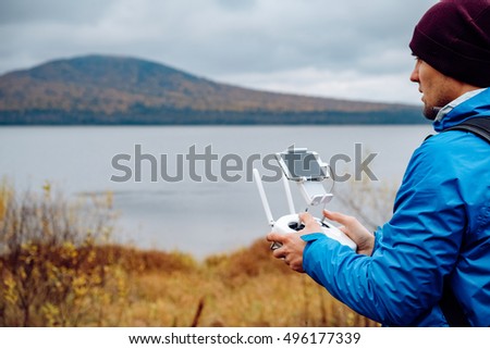 Man with drone flying at the outdoor. Man playing with drone