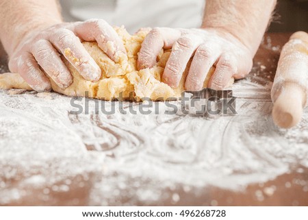 Pair of hands kneading dough