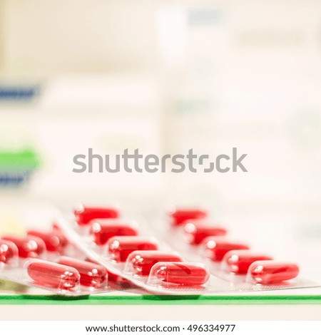 Medicine green and yellow pills or capsules on white background with copy space. Drug prescription for treatment medication. Pharmaceutical medicament, cure in container for health. Antibiotic
