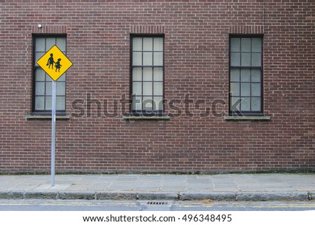 Sign of children against the background of a brick wall building