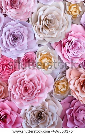 Colorful flowers paper background. Red, pink, purple, brown, yellow and peach handmade paper roses