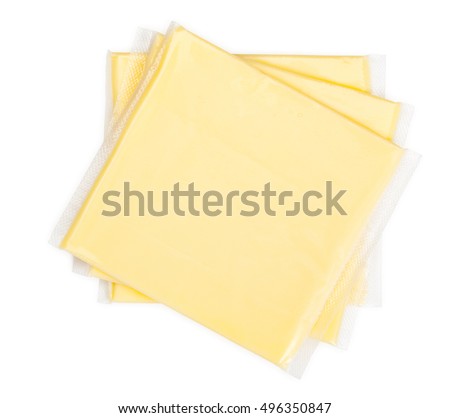Three yellow cheese slices packaged on white background. Close-up, top view.  Royalty-Free Stock Photo #496350847