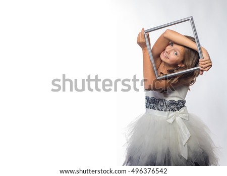 Emotional blonde girl in a white dress in a frame on a white background