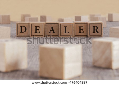 DEALER word written on building blocks concept