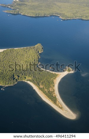 Aerial picture of a beautiful paradise island on the coast of Vancouver Island. Taken early morning near Tofino, BC, Canada.