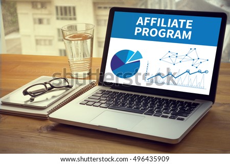 AFFILIATE PROGRAM Computing Computer  Laptop with screen on table Silhouette and filter sun Royalty-Free Stock Photo #496435909