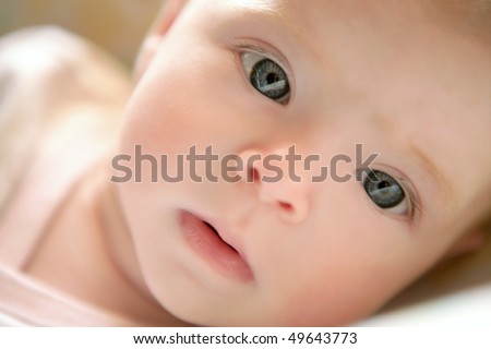 Blond little baby laying on bed portrait horizontal image