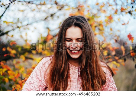 Closeup outdoors portrait of gorgeous young  Caucasian woman.  outdoors in park on sunny fall day. colorful autumn portrait. Portrait of a beautiful, dreamy  girl with long  hair. in autumn park