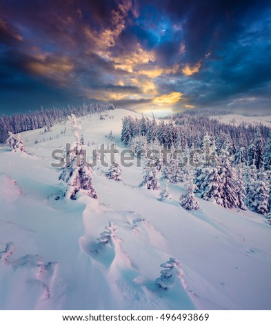 Dark winter scene in the mountains. Dramatic sunset in the Carpathians, ukraine, Europe. Artistic style post processed photo.