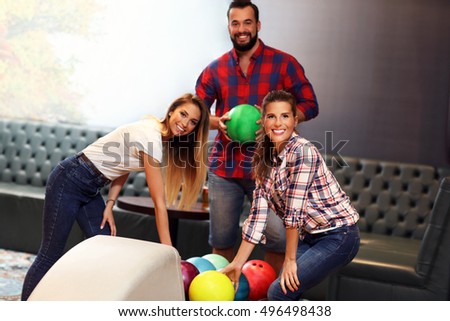 Picture showing group of friends playing bowling