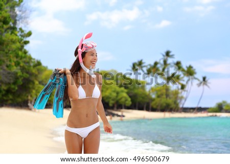 Beach vacation snorkel girl snorkeling with mask and fins. Bikini woman relaxing on summer tropical getaway doing snorkeling activity with snorkel tuba and flippers sun tanning. Caribbean destination.