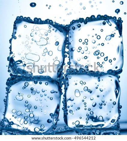 close up of ice cube splash in water on white background