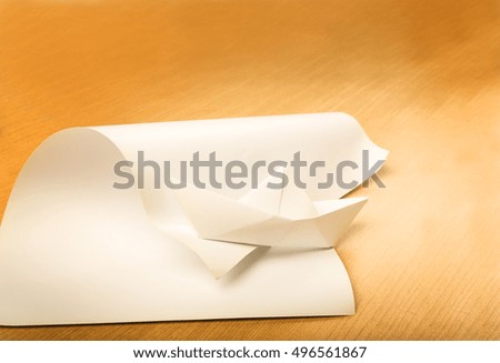 thinking differently concept, great ideas come from simple things concept, paper boat and paper on wood background