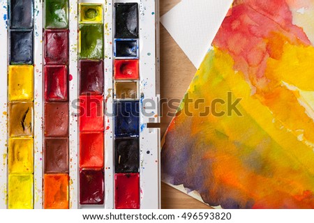  watercolor paints on wooden background