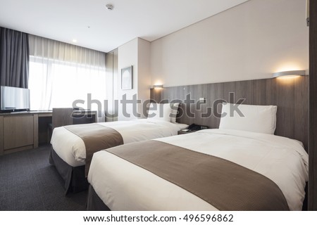 A hotel room, bedroom with two beds, curtain, lighting front view at the day in seoul, south korea. Royalty-Free Stock Photo #496596862