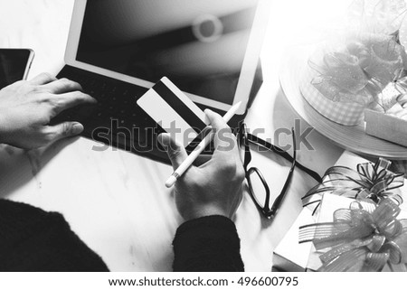 Creative choosing gift with laptop computer and smart phone on mable desk,filter film effect,black and white