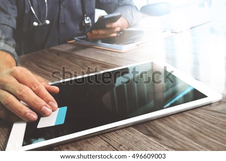 Medical technology concept. Doctor hand working with modern digital tablet and laptop computer with chart interface, Sun flare effect photo