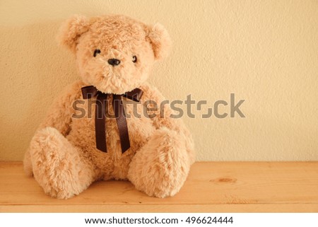 Teddy Bear toy alone on wooden table