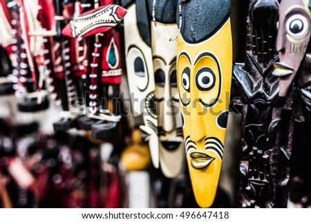 many colorful african traditional masks at a market