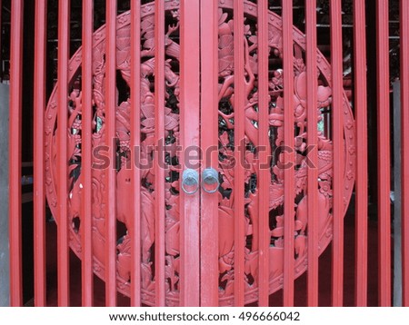 Red Chinese wooden door with wood carving decoration