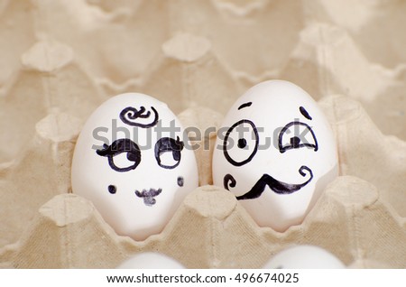 Two eggs with painted faces, a lady and a gentleman