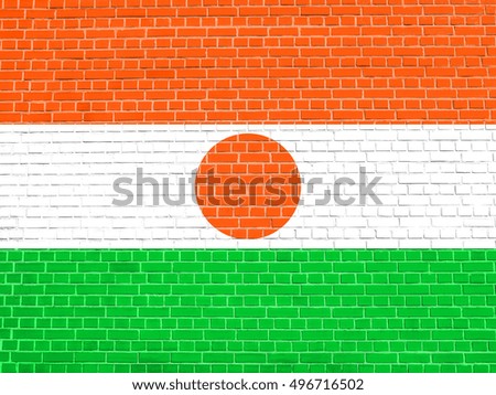 Nigerien national official flag. African patriotic symbol, banner, element, background. Flag of Niger on brick wall texture background