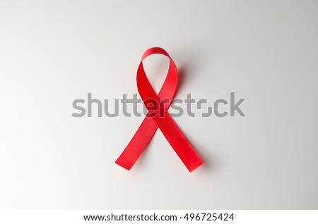 Red ribbon HIV, AIDS on gray background, Awareness, Medical sign. copy space. Royalty-Free Stock Photo #496725424