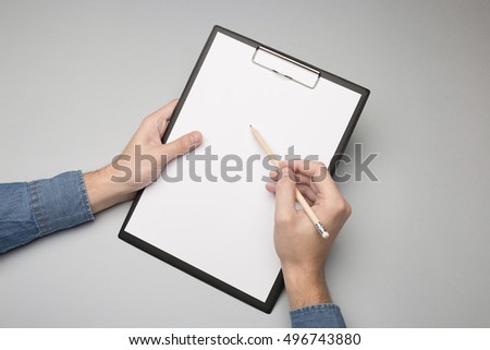 Hands holding clipboard and write / Mock-up.