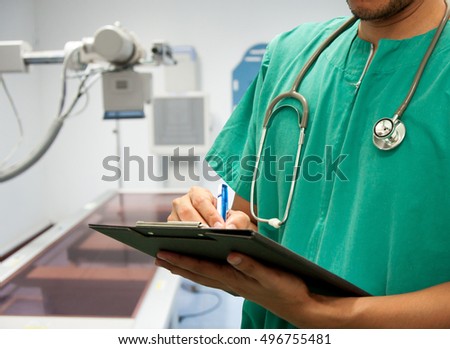 Doctor writing a medical prescription in hospital