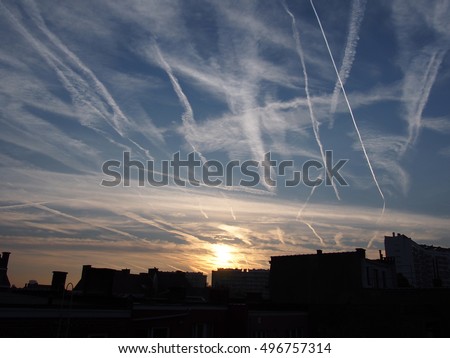 con trails and sunrise glow Royalty-Free Stock Photo #496757314