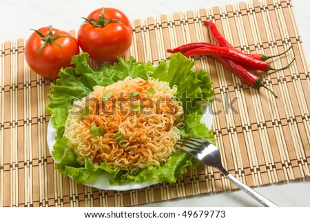 Dish of noodles on lettuce leaf