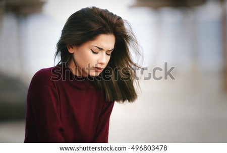 Sad Depressed Teen Girl Sitting alone on the Beach Royalty-Free Stock Photo #496803478