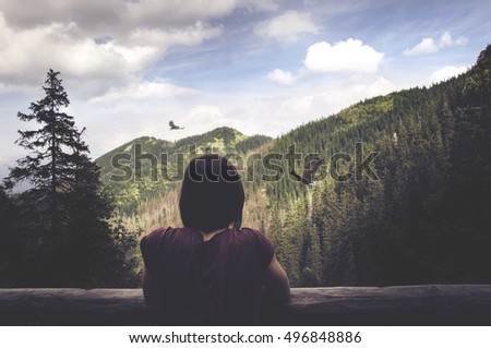 girl watching eagles in the mountains