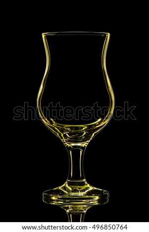 Silhouette of yellow cocktail glass with clipping path on black background.