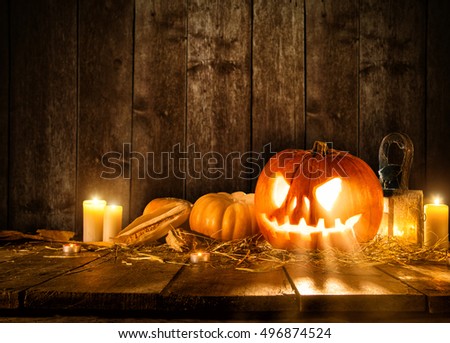 Scary halloween pumpkin on wooden planks. Empty space for text