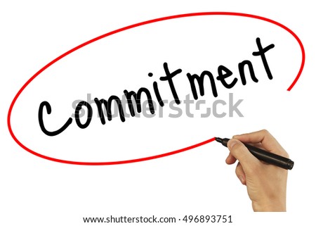 Man Hand writing Commitment with black marker on visual screen. Isolated on background. Business, technology, internet concept. Stock Photo