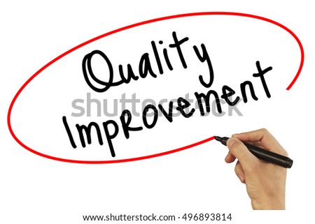 Man Hand writing Quality Improvement with black marker on visual screen. Isolated on background. Business, technology, internet concept. Stock Photo