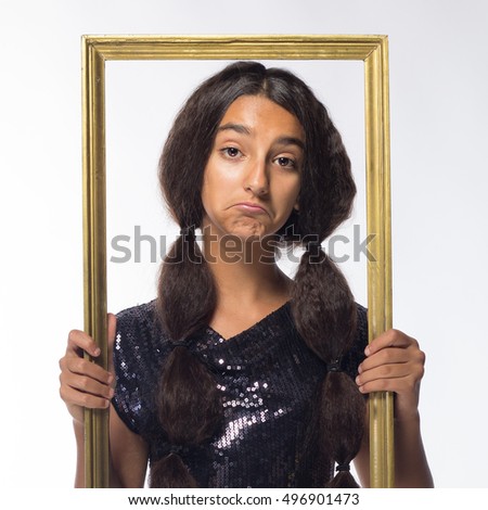 young brunette girl with long hair in black dress with a frame on a white background