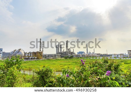 Oil refineries and storage tanks in the plant under the background of blue sky white clouds