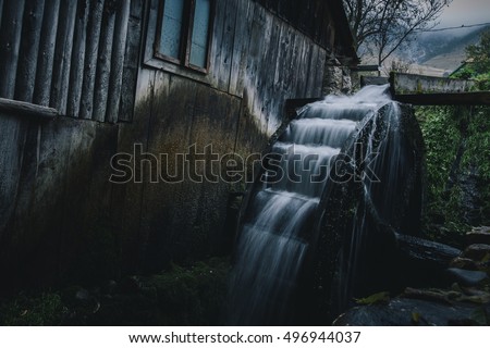 Working watermill wheel with falling water