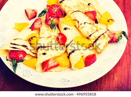 Vintage photo of homemade pancakes with fresh fruit